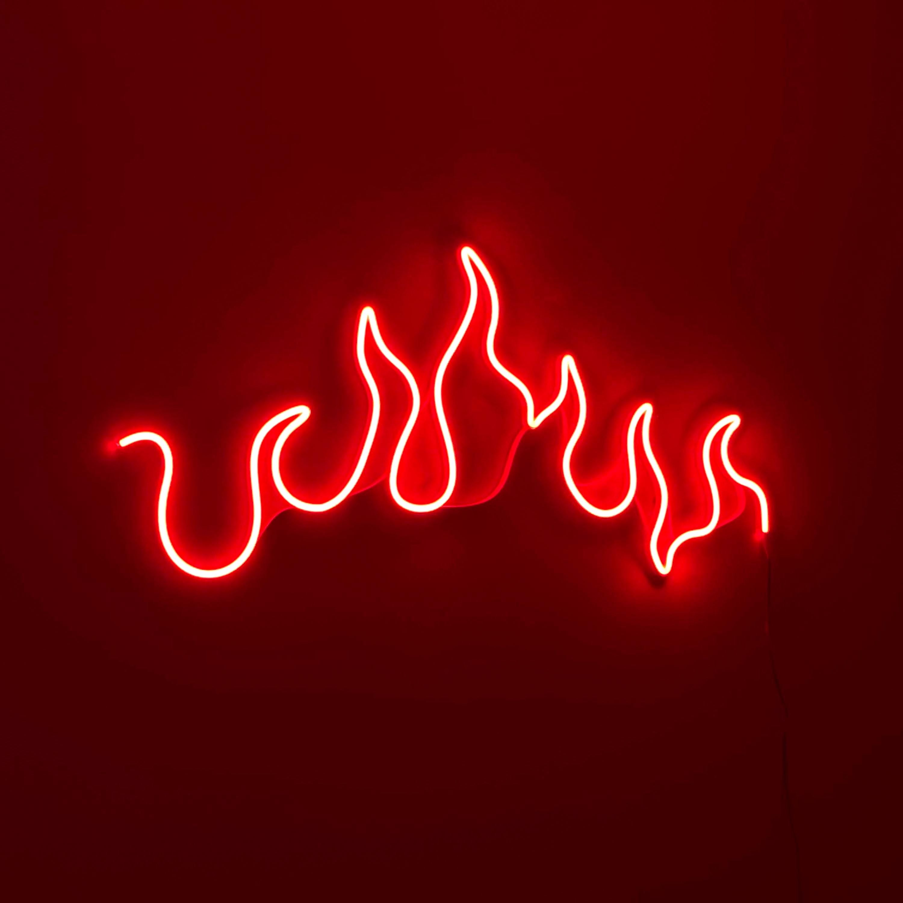 a red neon sign with flames on it